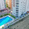 Двухкомнатная квартира с зеленым садом и открытой парковкой с видом на море в районе Махмутлар